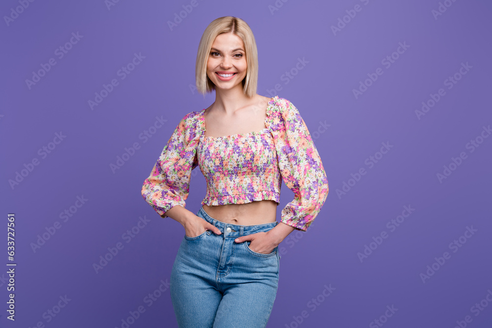 Photo of sweet shiny lady wear flower print crop top smiling isolated violet color background Photo of sweet shiny lady wear flower print crop top smiling isolated violet color background