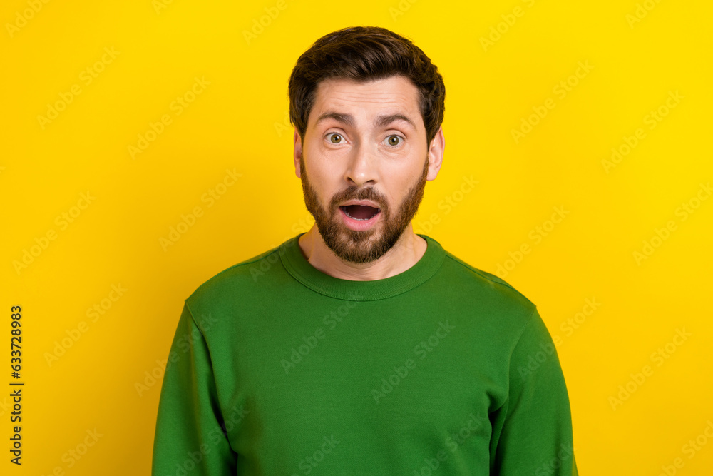 Photo of astonished impressed man wearing green clothes wow seasonal special black friday offer isolated on yellow color background Photo of astonished impressed man wearing green clothes wow seasonal special black friday offer isolated on yellow color background