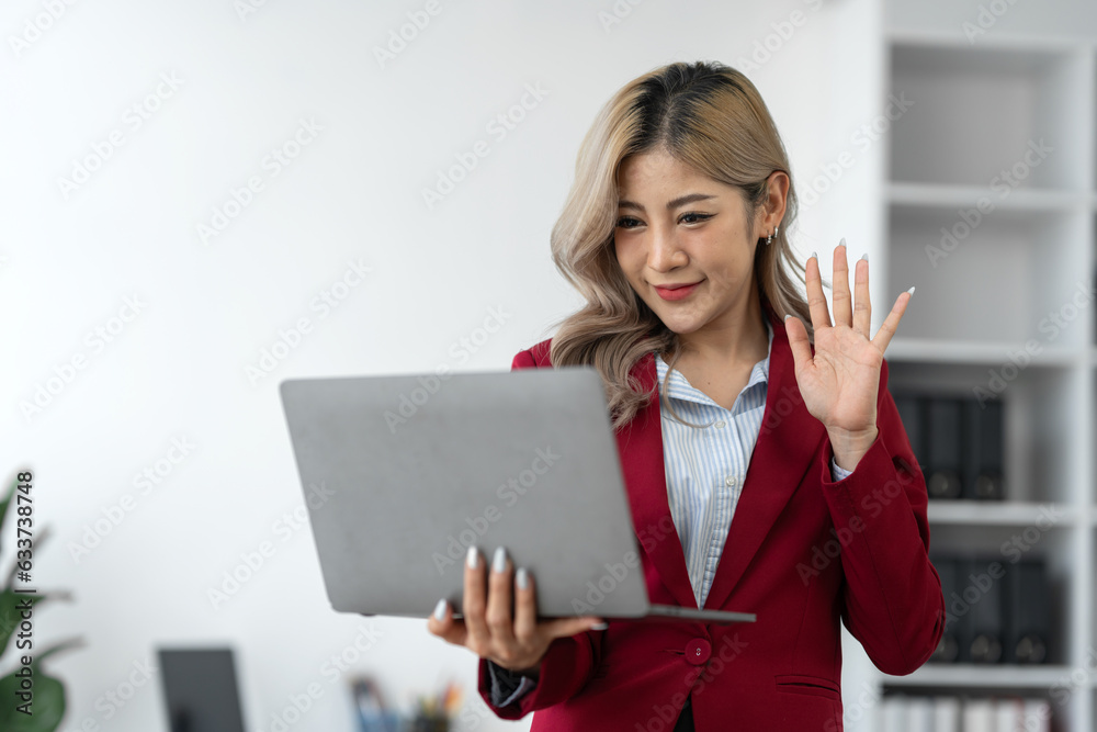 Portrait, Asian businesswoman or professional and confident female manager in standing suit holding a laptop computer to work, contact, search for business information online in the office