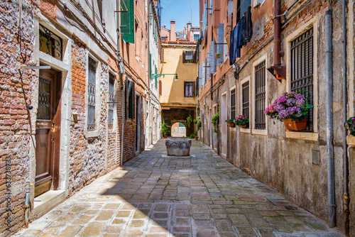 Photography Narrow pedestrian cobblestone old alleys in Venice, Italy