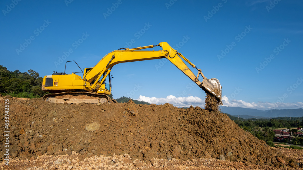 Obraz premium An excavator machine digging soil at a construction project site, showcasing heavy machinery in action, earthmoving work, and industrial development.
