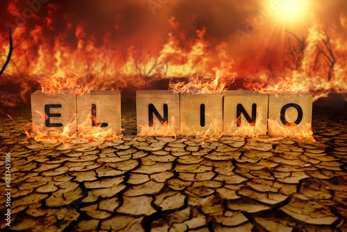 Wooden block of El Nino on the cracked mud and wild fire background. climate change and global warming concept photo