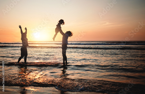 Silhouette, sunset and dad lifting child in air at beach with lgbt family and waves in the ocean with fun and support on adventure. Gay parents, kid and father play with girl in the sea with love