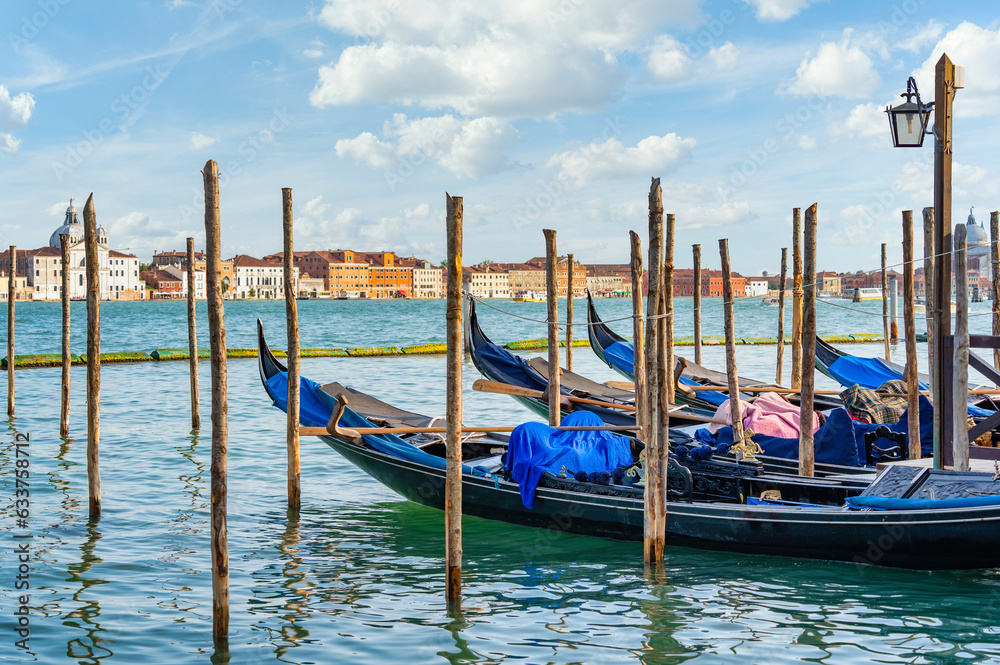 Colorful picture with gondolas moored on Grand Canal near Saint Mark square, in Venice Italy.