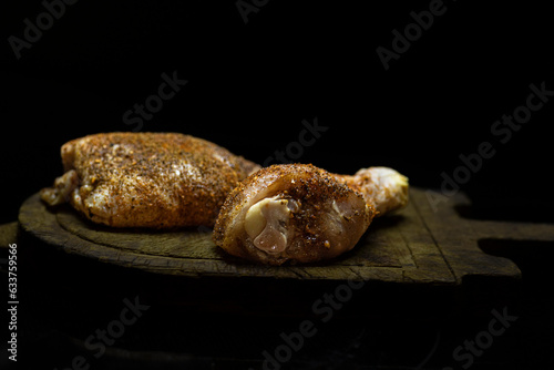 Raw seasoned chicken thigh and leg.