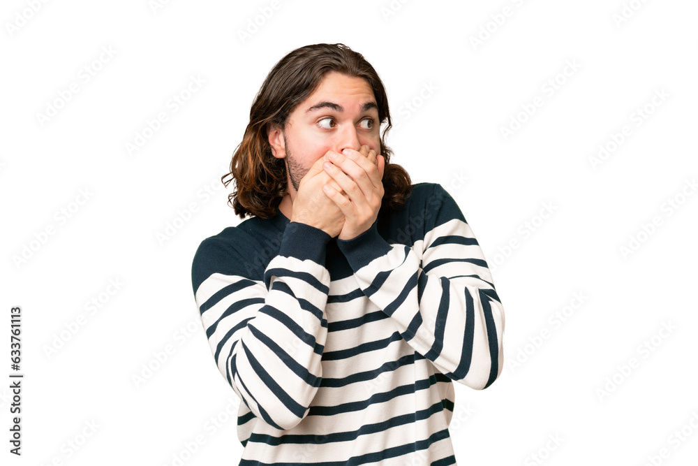 Young handsome man over isolated background covering mouth and looking to the side