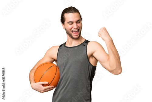 Young handsome man isolated on green chroma background playing basketball