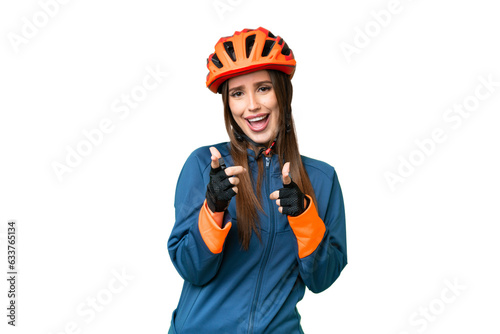 Young cyclist woman over isolated chroma key background pointing to the front and smiling