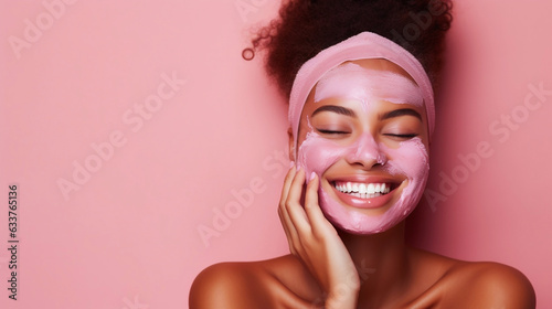 Close up portrait of young black women smiling with pink clay mask on face natural organic skincare beauty shot