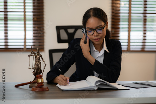 Lawyers Asiawoman   having through online Concepts  of Legal services at the law office. photo