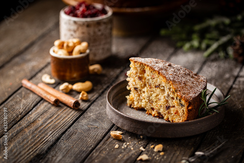 Traditional Christmas cake pudding with fruits and nuts with Christmas decorations  dark background