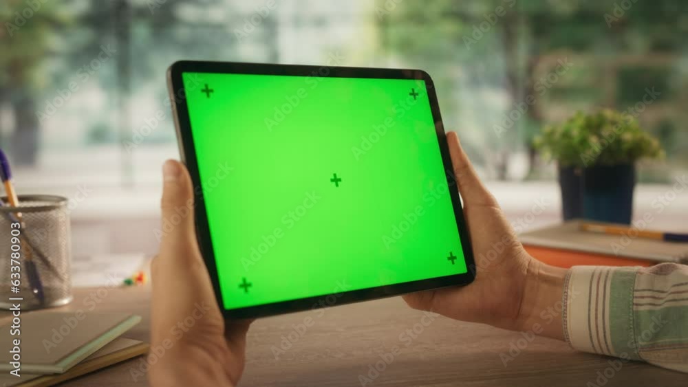 Marketing Manager Streaming a Video Presentation on a Tablet Computer with Mock Up Green Screen Vertical Display. Concept for Online Communication, Internet Branding, Business Promotions