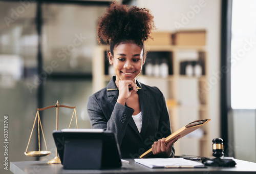 African american lawyer woman in suit holding envelope of business contract and reading information on