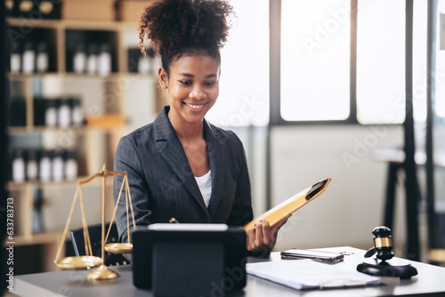 African american lawyer woman in suit holding envelope of business contract and writing information in photo