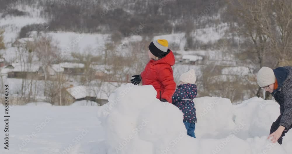 Children playing with snowballs. Family have fun outdoors, winter holidays. Snowball fight Children playing with snowballs. Family have fun outdoors, winter holidays. Snowball fight