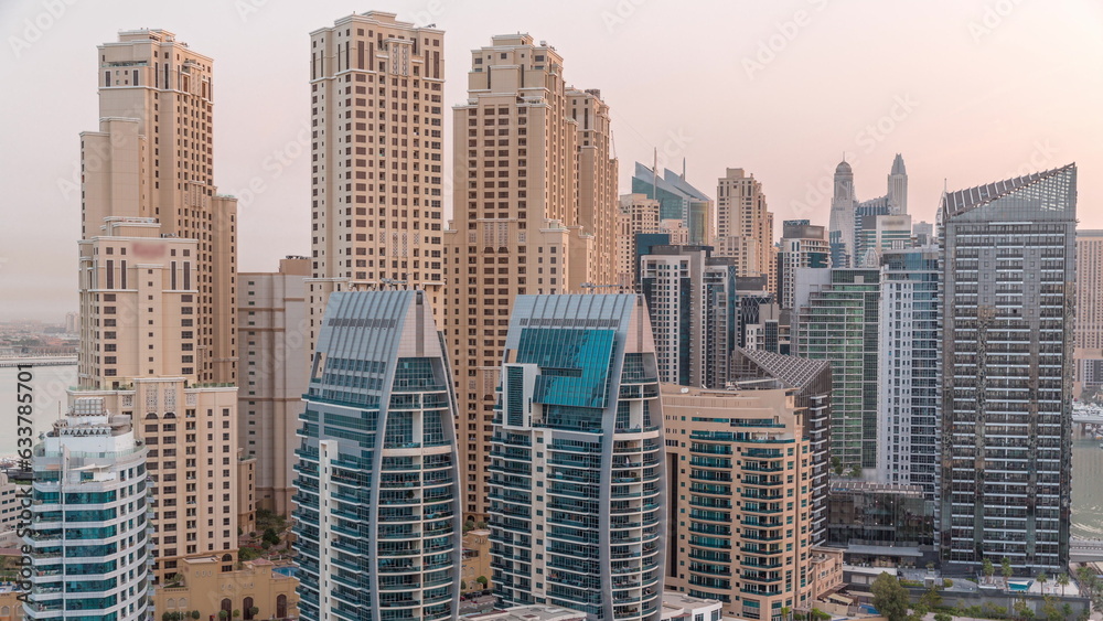 Dubai Marina skyscrapers and JBR district with luxury buildings and resorts aerial night to day timelapse Dubai Marina skyscrapers and JBR district with luxury buildings and resorts aerial night to day timelapse