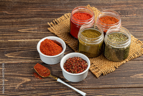 A set of spices on a light background in a glass bowl. Enhancement of taste.