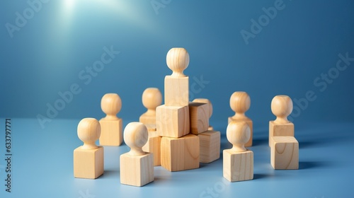 Many wooden cubes with people symbols and one with a lightbulb symbol on blue background. 