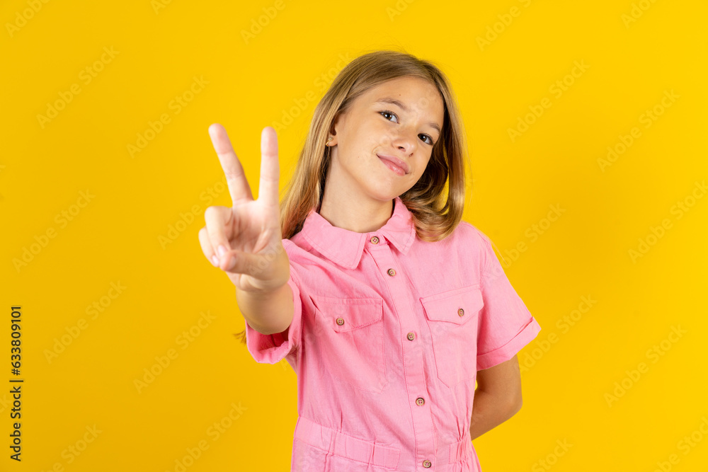 young beautiful blonde kid girl over yellow studio background directs fingers at camera selects someone. I recommend you. Best choice young beautiful blonde kid girl over yellow studio background directs fingers at camera selects someone. I recommend you. Best choice