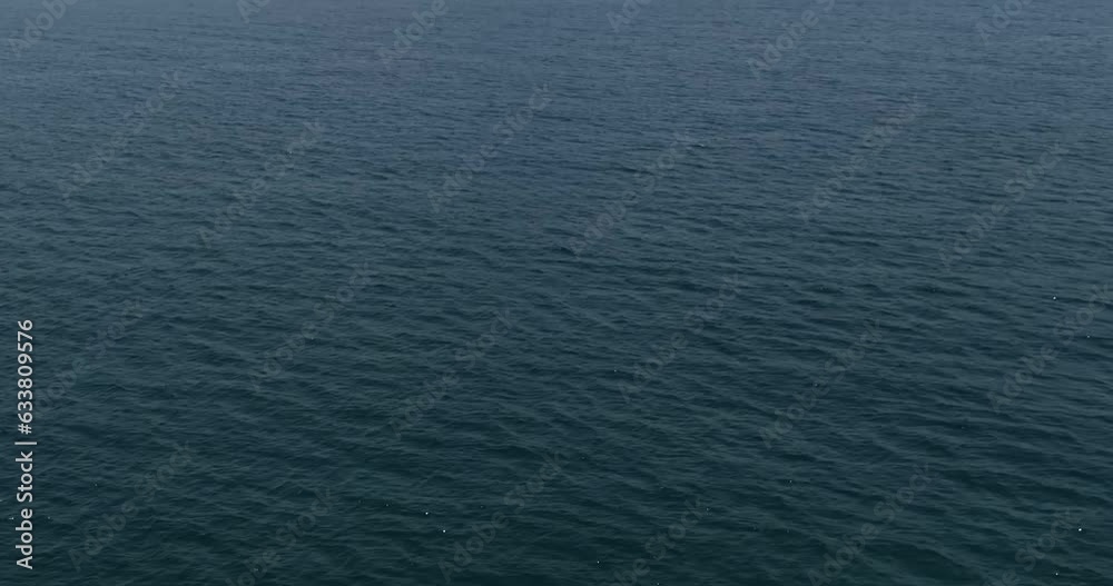 The drone flies over the waves of the sea towards the city on the shore. Dubai, United Arab Emirates The drone flies over the waves of the sea towards the city on the shore. Dubai, United Arab Emirates