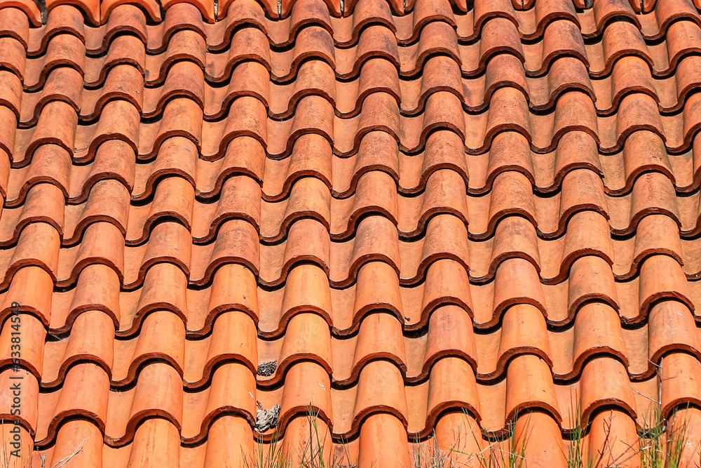 Old roof tiled with S-shaped clay tiles. Photo in perspective with selective focus Old roof tiled with S-shaped clay tiles. Photo in perspective with selective focus