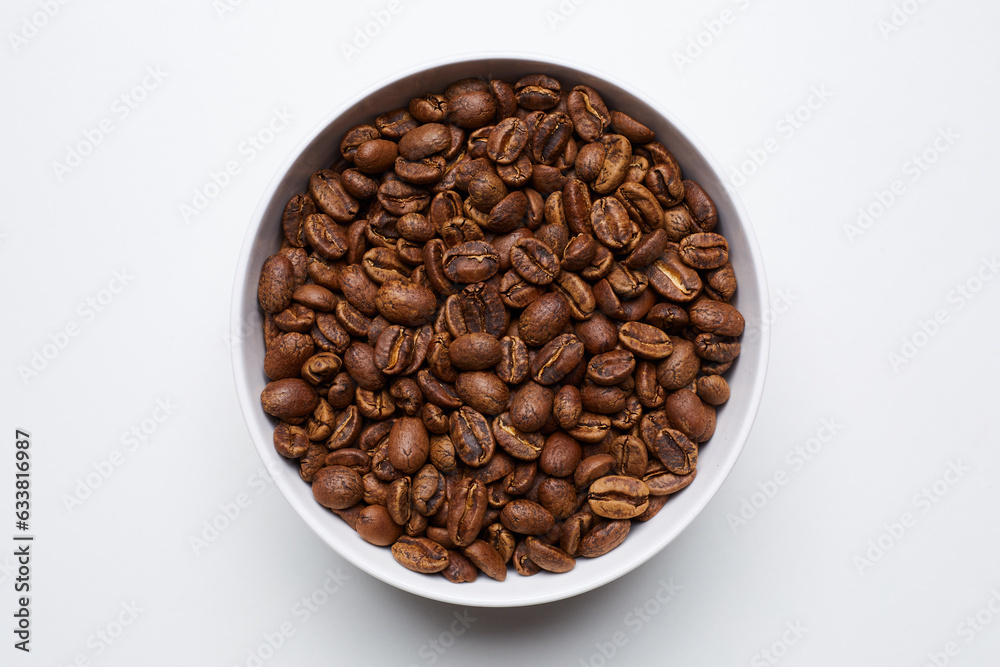 roased coffee beans in bowl on white background. Still Photo roased coffee beans in bowl on white background. Still Photo