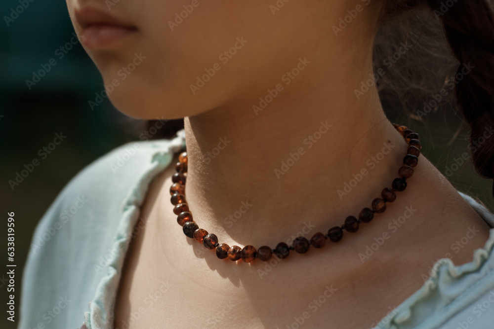 Amber beads close-up on the girl's neck