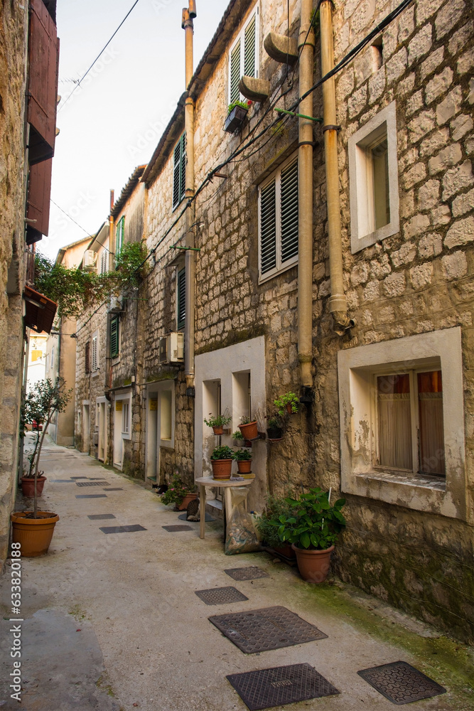 A residential street in the historic coastal village of Kastel Gomilica in Kastela, Croatia