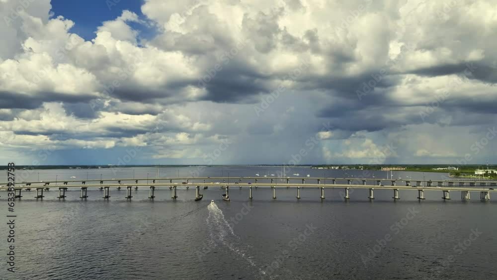Aerial view of Barron Collier Bridge and Gilchrist Bridge in Florida with moving traffic. Transportation infrastructure in Charlotte County connecting Punta Gorda and Port Charlotte over Peace River Aerial view of Barron Collier Bridge and Gilchrist Bridge in Florida with moving traffic. Transportation infrastructure in Charlotte County connecting Punta Gorda and Port Charlotte over Peace River