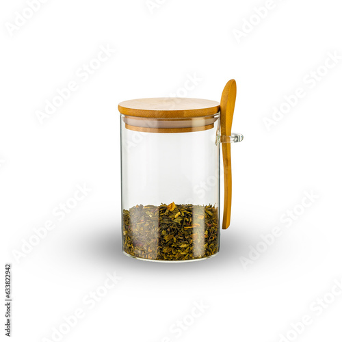 glass jar and wooden spoon with tea leaves isolated on white