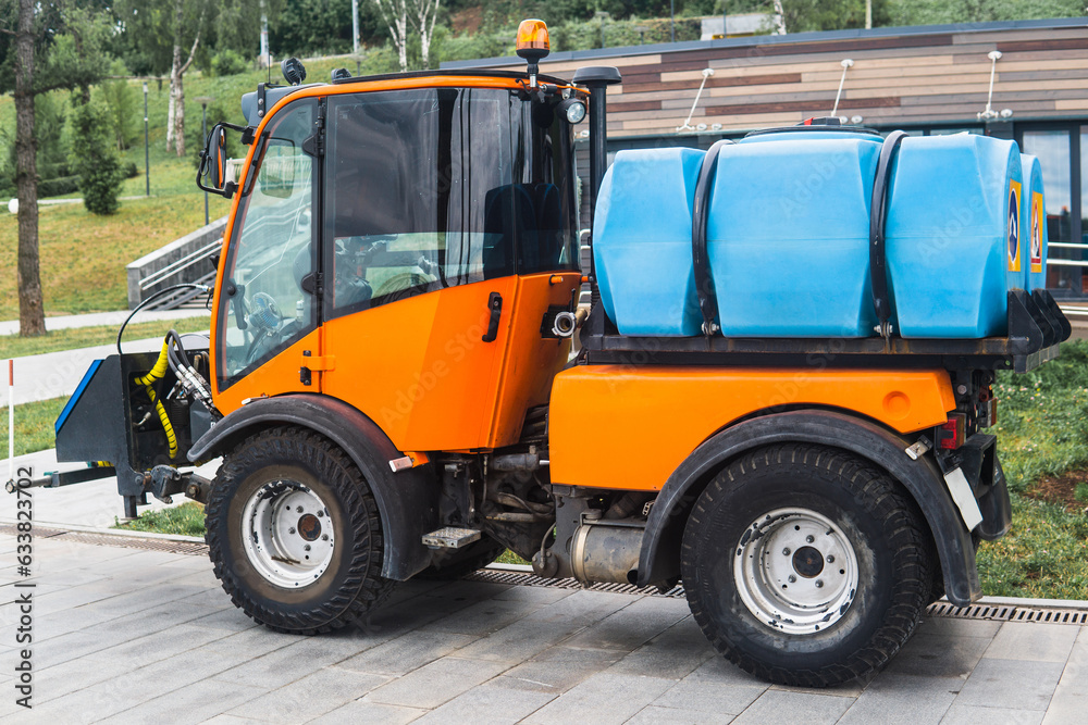 small tank truck for cleaning paths and watering plants in the city park