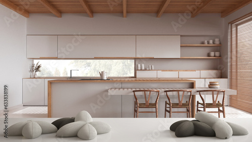 White table, desk or shelf with five soft white pillows in the shape of stars or flowers, over scandinavian japandi kitchen, minimalist architecture interior designkitchen,island, photo