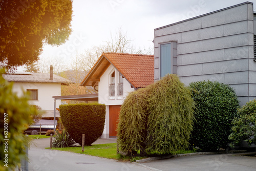 Lustenau, Austria - 04 20 2023: Modern private house in the Alpine village. Concrete facade of the private house. Neat, tidy well-kept house in Austrian countryside. Residential area. Living concept. photo