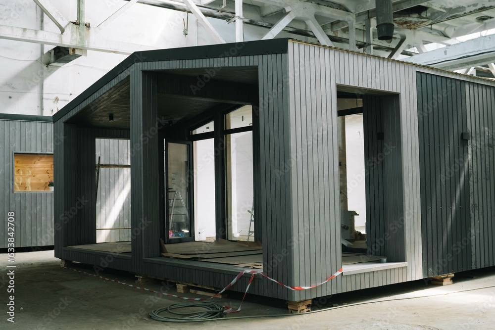 Fototapeta premium A new wooden modular prefabricated house inside in manufacturing facility