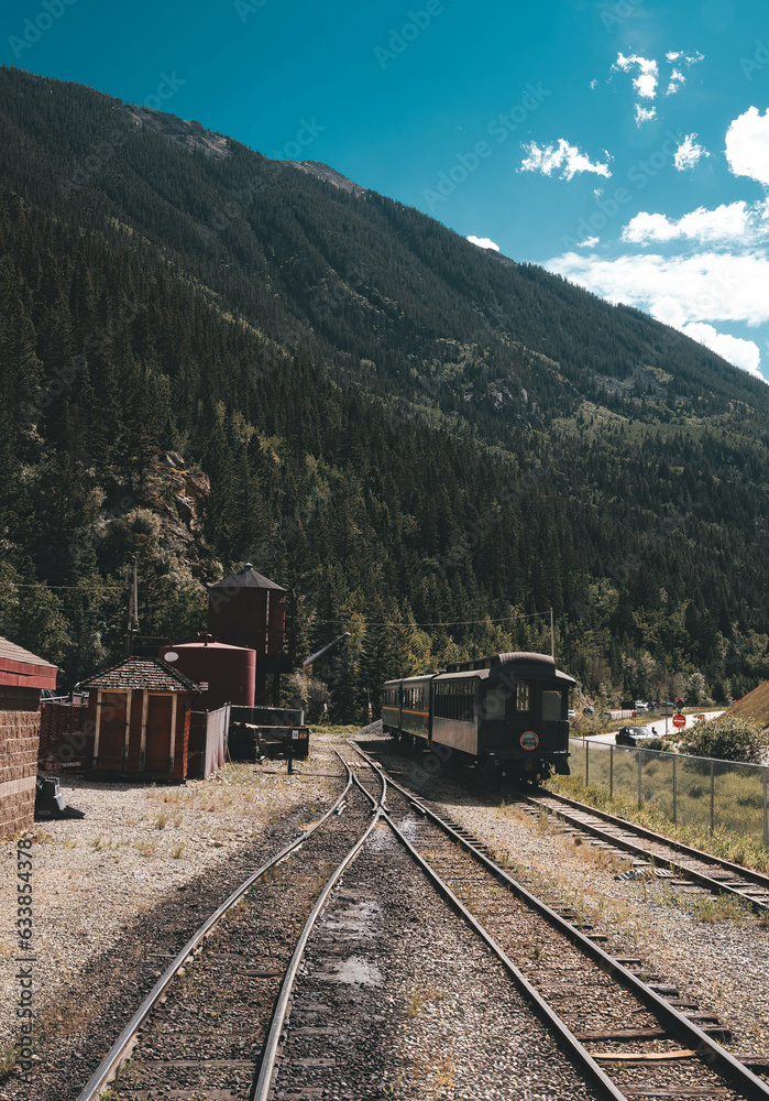 Wild West train between mountains at noon
