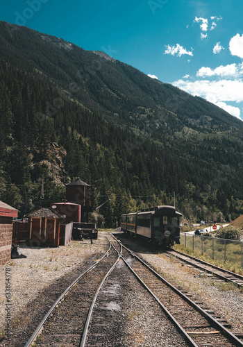 Wild West train between mountains at noon