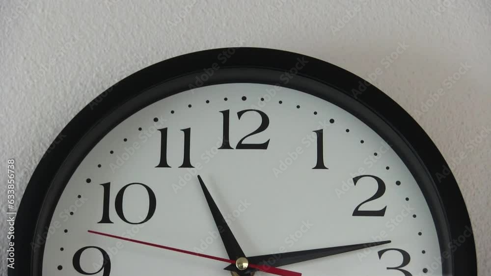 Red Second Hand Moving Across Analog Clock Face From 9 To 3 With White Wall Background
Red Second Hand Moving Across Analog Clock Face From 9 To 3 With White Wall Background