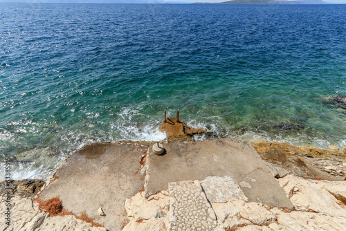 Dangerous entrance to the water on a metal ladder in Croatia

 photo