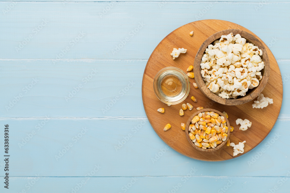 Prepared popcorn with ingredients on wooden background, top view Prepared popcorn with ingredients on wooden background, top view