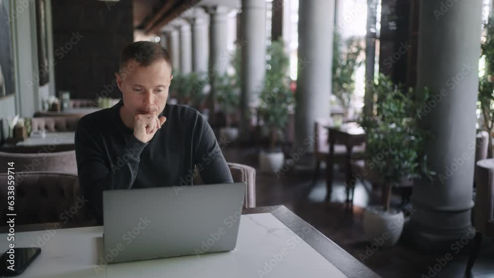 Businessman Working Online With Laptop In Cafe In Daytime, Portrait, Person Monitoring Stock Rates Businessman Working Online With Laptop In Cafe In Daytime, Portrait, Person Monitoring Stock Rates