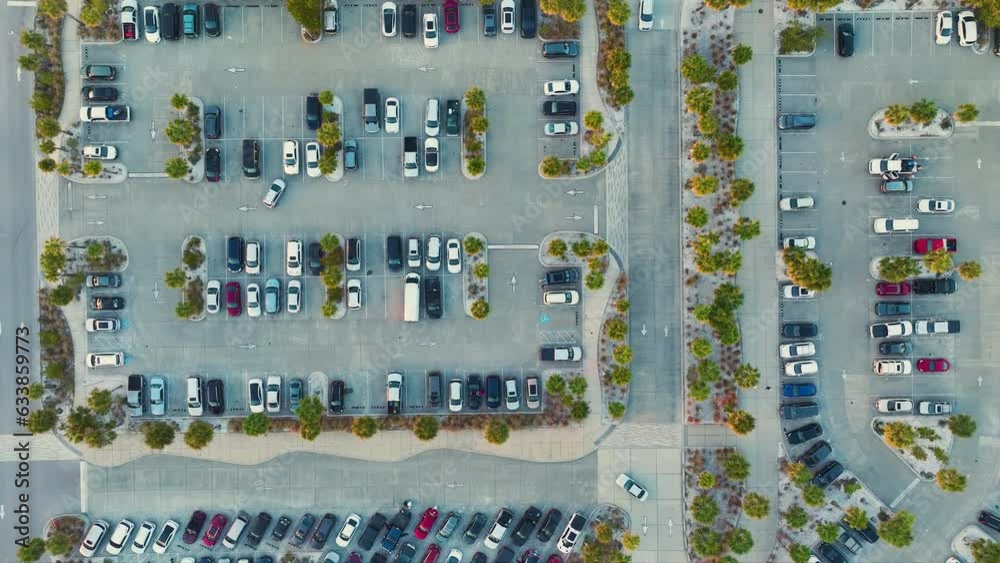 Aerial view of large parking lot with many parked colorful cars ...