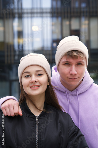 Portrait of happy young couple in hats outdoors posing, urban street style clothes  © Евгений Шемякин
