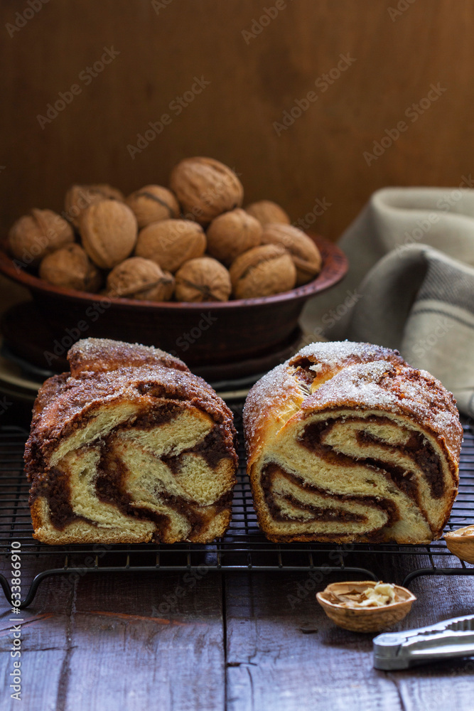 Traditional Easter bread with chocolate and nut filling on a wooden background.
