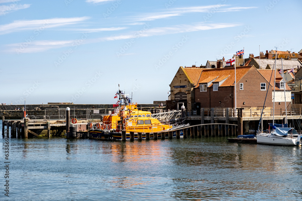 Whitby lifeboat moored outside the RNLI lifeboat shed in Whitby marina on the North Yorkshire coast