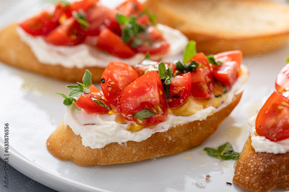 Tomato basil and cream cheese bruschettas with fresh cherry tomatoes