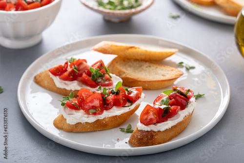 Tomato basil and cream cheese bruschettas with fresh cherry tomatoes