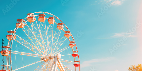 Fotobehang Attraction in amusement parks - Ferris wheel against bright blue sky, copy space for text