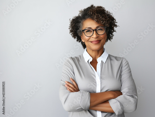 Portrait of a Smiling African American Business Woman middle age 50s 40s arms crossed isolated white background