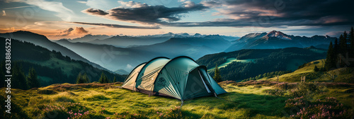 camping tent on mountain peak at sunrise, travel and vacation concept photo
