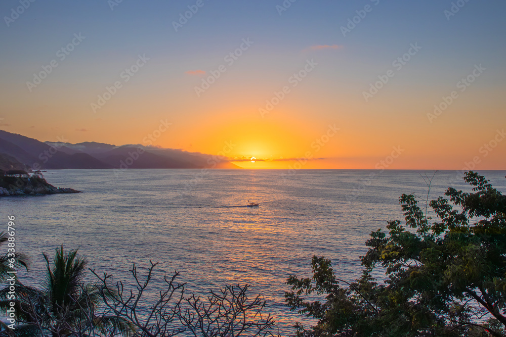 A beautiful sunset by the ocean in Mismaloya Puerto Vallarta south coast